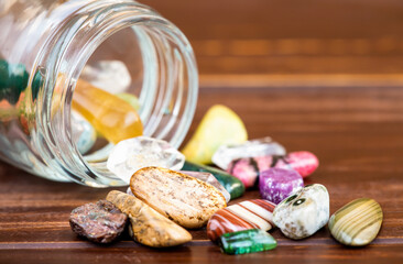 Colorful mineral stones with glass jar. Gemstone jewelry background with copy space.