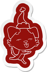 cartoon  sticker of a dog sticking out tongue wearing santa hat
