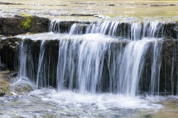 Fototapeta na wymiar Natural waterfall over rocks