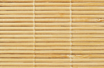 Light brown asian bamboo reed mat texture as background 