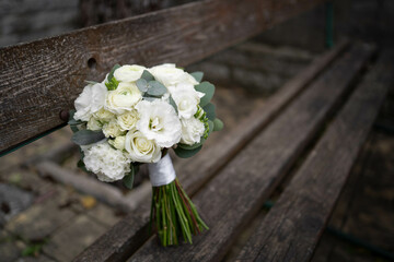 Wedding bouquet of white flowers - ranunculus, freesia, lisianthus.. Wedding. Bride and groom.