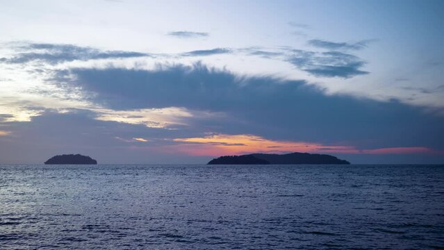 Silhouette of Sulug and Manukan Islands on Sunset Over Sea With Fluffy Low Clouds in Malaysia