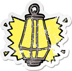 retro distressed sticker of a cartoon lantern shining