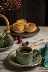 a cup of tea with choux pastry on the table