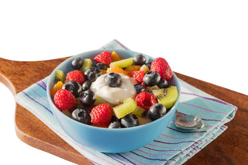 Fruit fresh salad in a ceramic bowl, white isolated background.
