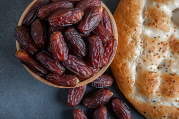Date fruits with Ramadan pita on black backgrpund
