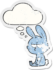 cute cartoon rabbit and thought bubble as a distressed worn sticker