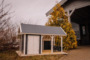 Home concepts, Miniature wooden house model with blurred green background. Selective soft focus.