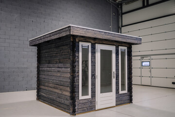 New pinewood shed on factory. Black painted storage hut.