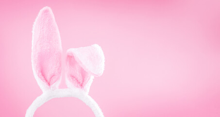 White easter rabbit ears on a light pink background with copy space