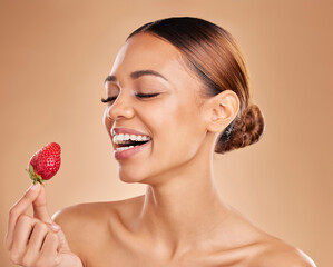 Beauty, skincare or happy woman with strawberry in studio on beige background for healthy nutrition or clean diet. Smile, face or funny girl model laughing or marketing natural fruits for wellness