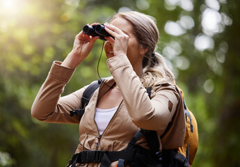 Binoculars, forest explore and woman on travel journey, jungle adventure or hiking for carbon footprint holiday. Happy hiker person trekking in tropical woods or eco green environment search or watch