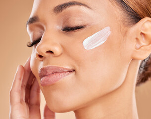 Woman, face and moisturizer cream for skincare beauty, cosmetics or dermatology against a studio...