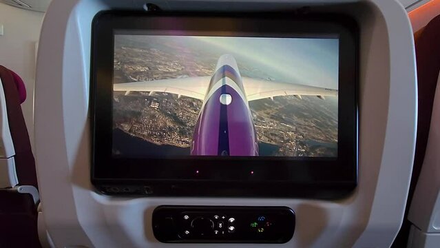 Airplane tv on back of seat of Thai Airways, showing the plane live.