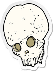 sticker of a cartoon spooky skull