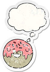 cartoon donut and thought bubble as a distressed worn sticker