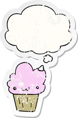 cartoon cupcake with face and thought bubble as a distressed worn sticker