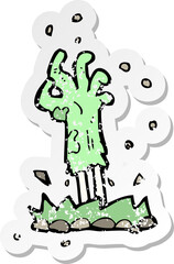 retro distressed sticker of a cartoon zombie hand rising from ground