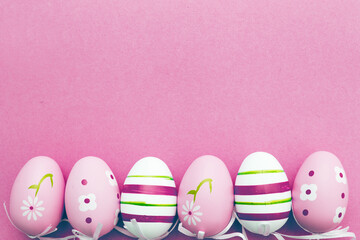 Fototapeta na wymiar easter colorful handmade painted eggs on pink background with copy space
