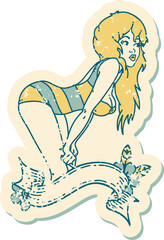 distressed sticker tattoo style icon  of a pinup girl in swimming costume with banner