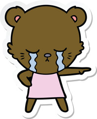 crying cartoon bear in dress pointing