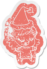 happy cartoon distressed sticker of a elf girl wearing santa hat