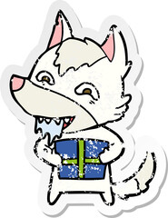 distressed sticker of a cartoon hungry wolf holding christmas present