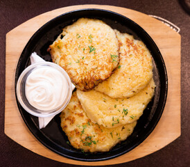 Potato pancakes with sour cream closeup. Belorussian cuisine