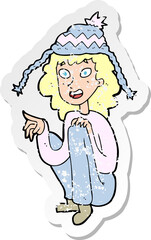 retro distressed sticker of a cartoon woman wearing winter hat