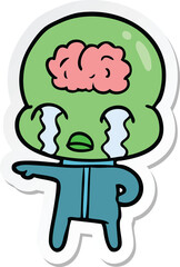sticker of a cartoon big brain alien crying