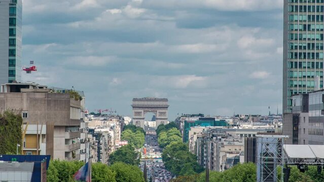 Aerial view from Defense business district to the Arc de Triumph timelapse. Skyscrapers and traffic on road. Cloudy sky at summer day. Paris, France