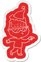 cartoon  sticker of a boy wearing sunglasses pointing wearing santa hat