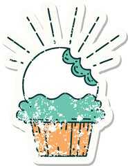 grunge sticker of tattoo style cupcake with missing bite