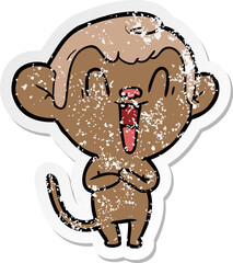 distressed sticker of a cartoon laughing monkey