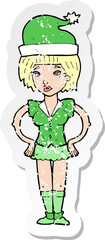 retro distressed sticker of a cartoon woman in christmas elf outfit