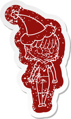 cartoon distressed sticker of a woman wearing santa hat