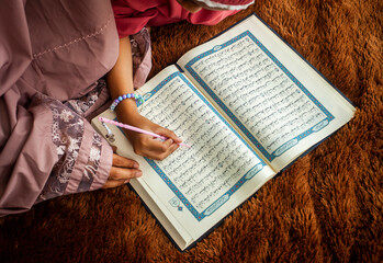 Muslims are reading the holy book Al-Quran on the sidelines of fasting during Ramadan.