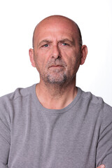 Fototapeta premium Close up headshot confident serious concentrated man over 50 looking at camera studio portrait, isolated on white studio background