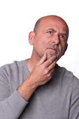 Naklejka premium Close up headshot confident serious concentrated man over 50 looking at camera studio portrait, isolated on white studio background