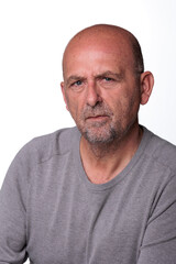 Fototapeta premium Close up headshot confident serious concentrated man over 50 looking at camera studio portrait, isolated on white studio background