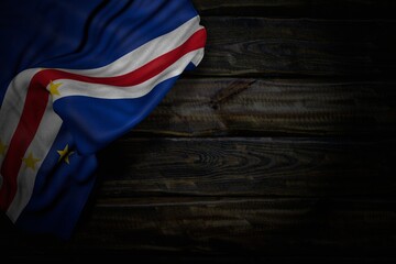 nice any celebration flag 3d illustration. - dark picture of Cabo Verde flag with big folds on old wood with free place for your content