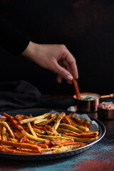 Healthy homemade oven baked sweet potato and carrot fries served with yogurt and green onion sauce. Low calorie vegetarian snack