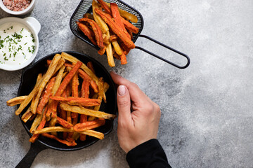 Healthy homemade oven baked sweet potato and carrot fries served with yogurt and green onion sauce....