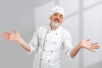 Chef-cooker in a chef's hat and jacket. Senior disappointing baker man wearing a chef's outfit....
