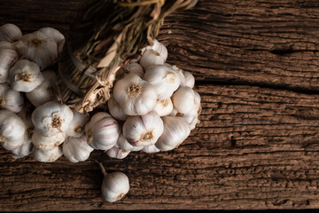 Garlic on wood table close up top view.