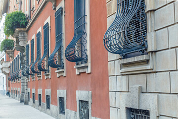 Residential building with wrought iron bars on the windows in Milan