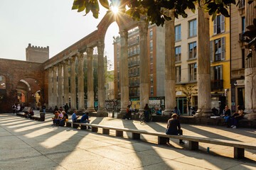 Shadows on the square from the ancient arch with columns on a sunny day