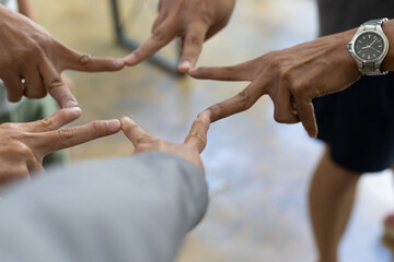 Stack of hands showing unity and teamwork. Group of friends put their hands together.