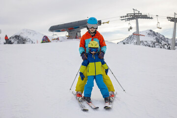 Fototapeta na wymiar Happy family, enjoying ski holiday with children, sunny beautiful weather