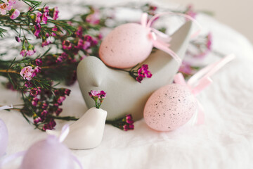 Easter eggs with flowers on white linen fabric. Spring and Easter concept.
